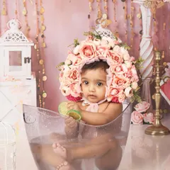 A fun and refreshing "milk bath" style shoot for a nine-month-old. The floral bonnet and citrus slices add a unique and artistic touch to this playful session.