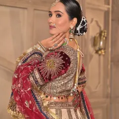 This view highlights the intricate details of the blouse and the elegant bridal hairstyle. The makeup is kept sophisticated to balance the grandeur of the entire ensemble.