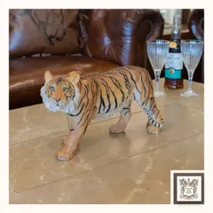 Perfectly poised on a coffee table, this majestic tiger figurine adds a touch of bold luxury to any space. I selected this piece for its lifelike detail and ability to command a room with style and grace.