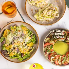 Our Citrus & Shaved Fennel salad is featured here, a bright and aromatic dish with olives, mint, and toasted hazelnuts.