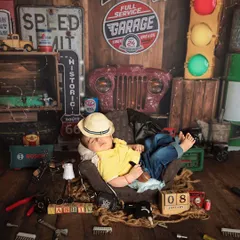 For the little boy who's ready to take on the world. This vintage garage theme is perfect for a baby boy's newborn shoot, complete with tools, signs, and a tiny traffic light.