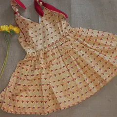 A closer look at another one of my handpicked fabric frocks. This one has a sweet floral print on a yellow base with contrasting red ties, showing how I love to mix and match prints and colors.