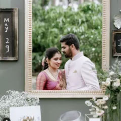 For Inchara and Chirag's engagement, we created this unique photo booth. A large, ornate golden frame was mounted on a custom green wall, allowing the couple and guests to capture picture-perfect memories.
