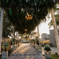 The guest experience begins the moment they arrive. We create grand, immersive entrances like this one, using lush greenery, elegant chandeliers, and a striking patterned walkway to build anticipation and make a powerful first impression for your conference or corporate retreat.
