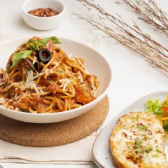 My Arrabiata pasta is a classic comfort dish. I prepare it with a tangy tomato sauce that has a little kick, fresh basil, and a generous sprinkle of parmesan cheese.
