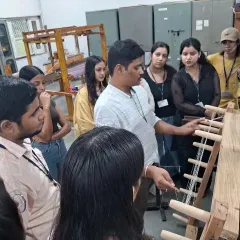 An expert at the Weaver's Service Centre demonstrates the intricate workings of a handloom to our attentive fashion and textile design students.