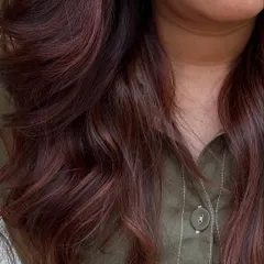 A 'Rose Gold' dream come true. We transformed her faded highlights into this stunning metallic pink shade. It’s a trendy yet sophisticated way to play with color.