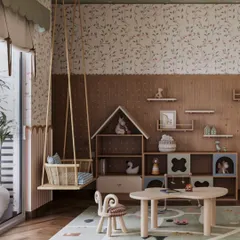 A gentle swing provides a perfect spot for reading or daydreaming. Positioned next to the custom wooden storage unit, this corner balances active play with moments of quiet reflection, all within a cohesive design language of natural wood and soft pastels.