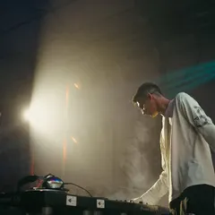 A profile shot captured mid-set at the Nesco concert. The stage smoke and spotlights highlight the professional production quality and atmosphere of my large-scale shows.