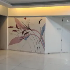 A wider view of the modern freestyle art in the living room. The design flows across the corner, making the space feel larger and more dynamic.