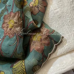 A close-up of the Kalamkari dupatta's scalloped border, which is delicately highlighted with sequins, laid against the intricate white-on-white Chikankari.