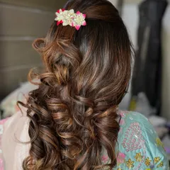 Another angle of the bouncy curls, showing how the style has volume at the crown and cascades down. This look is perfect for a wedding guest who wants a polished yet glamorous hairstyle.