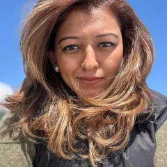 Another look at the face-framing balayage and layers. The wind-blown style shows how the color and cut work together to create effortless movement.