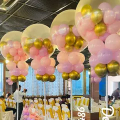 To fill a large party hall, I created these stunning balloon columns for a butterfly-themed birthday. Each column consists of a large clear bubble balloon filled with smaller pink and gold balloons, creating a magical floating effect.