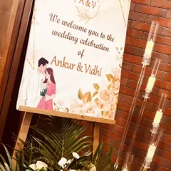A personalized welcome sign for Ankur and Vidhi's wedding celebration. The sign features a custom illustration of the couple, adding a sweet and personal touch to the entrance decor.