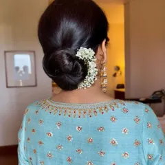 A look at the classic floral bun we created. It's a timeless hairstyle that adds a touch of grace to any look.
