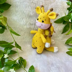 The giraffe and lion plushies sitting together. They make a perfect gift set for a safari or jungle-themed nursery.