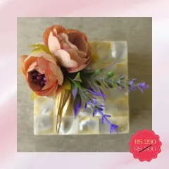 A beautiful mother-of-pearl box with floral decoration, available at a discounted price in my clearance sale. It's a perfect little box for storing trinkets or as a decorative piece.