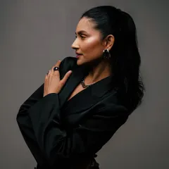 A dramatic, low-key portrait from a studio session. The lighting and pose create a moody and sophisticated feel, showing a different side of my creative expression.