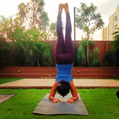 Practicing Pincha Mayurasana, or forearm stand, in the park. Inversions challenge me to find clarity and focus, reminding me that when the 'why' is clear, the 'how' appears.