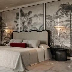 For this master bedroom, I designed a dramatic and moody retreat. The tropical-themed mural acts as a stunning art piece, creating an immersive backdrop that feels both relaxing and sophisticated, perfect for unwinding.