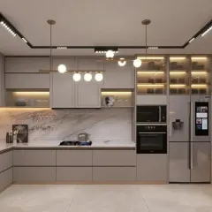 This spacious L-shaped kitchen features handleless light grey cabinetry and a smart refrigerator for a tech-integrated, modern look. We used track lighting and globe pendants to illuminate the space, while glass-front cabinets provide stylish storage.