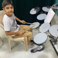 This young student is getting started with our drumset classes. We provide a supportive environment for kids to explore rhythm and build confidence on the electronic drums.