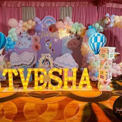 I love creating dreamy, pastel-themed parties. This first birthday setup for Tvesha features a whimsical unicorn and hot air balloon theme, complete with custom backdrops, cloud props, light-up marquee letters, and a full pastel balloon arch.