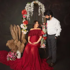 Feeling like a goddess in red. This maternity session was all about celebrating the power and beauty of motherhood with a stunning floral birdcage prop and a flowing gown to highlight the beautiful baby bump.