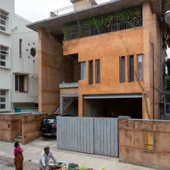 This is the exterior of a residence we designed in a dense Bangalore neighborhood. We used earth from the site itself and debris from the old, demolished house to construct the new walls, creating a structure that is both modern and deeply rooted in its own history and place.