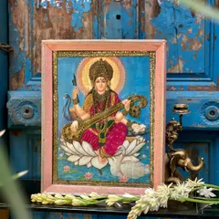 This is a cloth oleograph of Goddess Saraswati, a beautiful print by Raja Ravi Varma that we’ve reworked on cloth with delicate embroidery. It adds texture and a three-dimensional quality, giving new life to a classic piece of art.