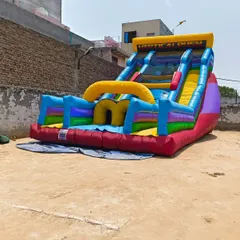 A 'Vertical Rush' style inflatable slide, featuring two climbing lanes and two steep slides. This is a competitive and thrilling attraction for older children and adults.