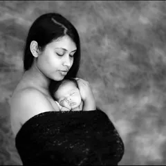 As a mother, I know this feeling so well. This classic black and white portrait captures the quiet, powerful bond between a mother and her newborn. It is an intimate, soulful moment that speaks directly to the heart, preserved as a piece of fine art.