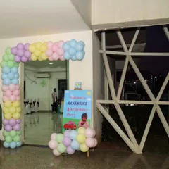 A cheerful pastel balloon arch and welcome sign for Aayansh's 4th birthday party.