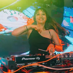 A candid shot capturing my joy while playing a high-energy set. Connecting with the audience through music is the best part of my job as a female DJ.