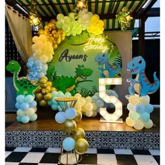 A fun Dinosaur-themed ring setup with a 'Happy Birthday' neon sign and a marquee number '5'.