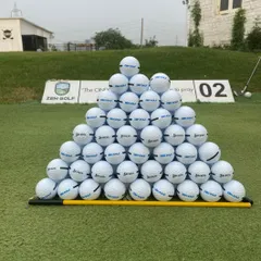 We ensure you have the best equipment for your practice. Here's a fresh pyramid of Srixon range balls, ready for your session.