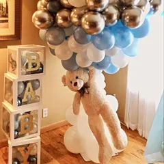 Our teddy bear theme is all about cuddly cuteness. Here, a fluffy teddy bear appears to be floating up with a column of balloons, next to custom "BABY" blocks filled with smaller balloons.