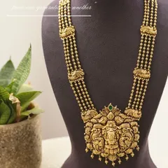 A product-focused shot for Manjali Jewellers. The styling is minimal to ensure this magnificent, traditional gold temple necklace is the undisputed hero of the image.
