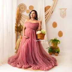 This shot captures a bright, happy expression, showcasing the beauty of the mauve gown and the charming studio set.