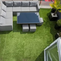 An overhead view of a completed terrace makeover. We covered the entire area with high-quality artificial turf, creating a soft, vibrant green space perfect for placing outdoor furniture and enjoying the open air.