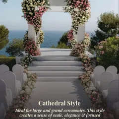 A classic cathedral-style floral arch frames the sea, creating a grand and elegant focal point for a large ceremony. The design focuses all attention on the couple and the stunning natural backdrop.