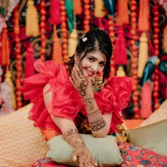 A beautiful shot of the bride showing off her intricate mehendi. Our vibrant decor, with its mix of textures and bright colors, provided the perfect backdrop for her photos.
