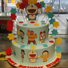 This two-tier Doraemon cake brings the whole gang together for a fun birthday celebration. It's decorated with edible images of Nobita, Shizuka, and friends, topped with colorful stars.