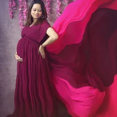 The beauty of a flowing gown in motion. In the studio, we can play with fabrics and lighting to create stunning, glamorous maternity photos like this one.