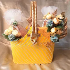 This festive yellow basket is a perfect multi-purpose gift for occasions like Ganesh Chaturthi or Paryushan. It's a vibrant and cheerful way to present your festive offerings.