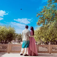 A pre-wedding shoot in Jaipur, with the couple looking out at the sky from a heritage location. I love using grand backdrops to tell your story.