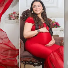 A seated portrait of a mom-to-be in a striking red gown. The ornate chair and soft lighting in the studio add to the regal and graceful feel of the photograph.