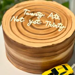 "Twenty Ate, Not yet Thirty." This witty 28th birthday cake is designed to look like a tree trunk, complete with a toy car driving on a fondant road.