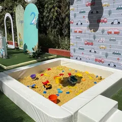 Our portable sandpit set up for an outdoor vehicle-themed birthday party. We provide clean sand and a variety of toys, offering a wonderful sensory play experience that can be placed in gardens or even indoors without any mess.